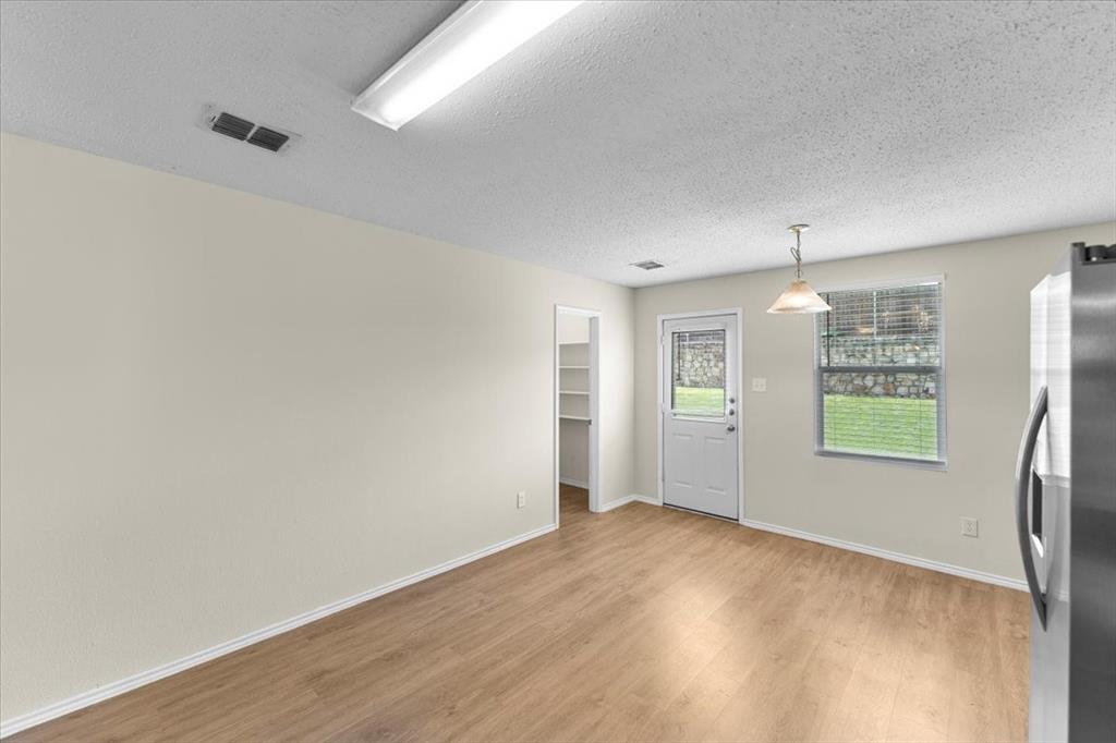 2633 Salt Maker Way Little Elm, TX 75068 - Photo 11 of 40 wooden floor in an empty room with a window