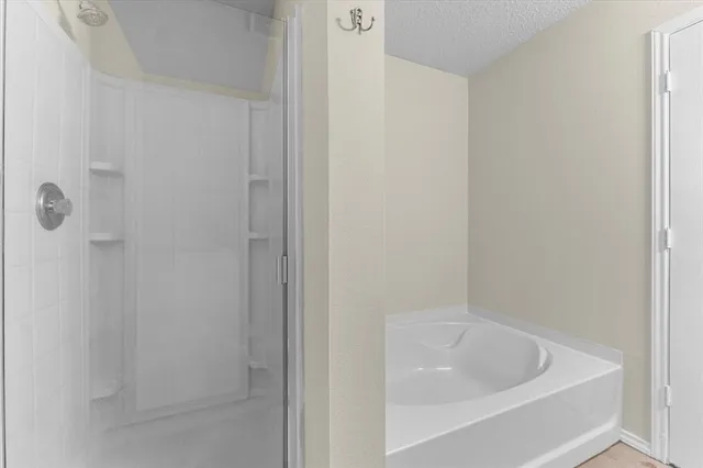 a white bath tub sitting next to a white sink