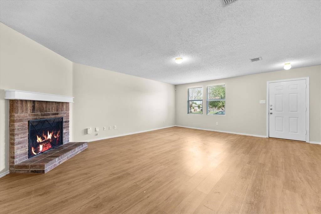 2633 Salt Maker Way Little Elm, TX 75068 - Photo 2 of 40 a view of an empty room with a fireplace and window