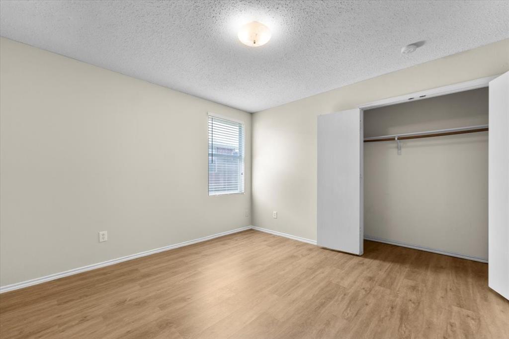 2633 Salt Maker Way Little Elm, TX 75068 - Photo 21 of 40 an empty room with wooden floor and windows