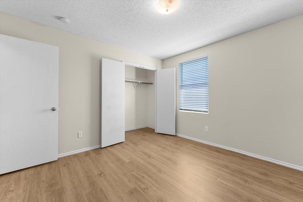 2633 Salt Maker Way Little Elm, TX 75068 - Photo 28 of 40 an empty room with wooden floor closet and windows