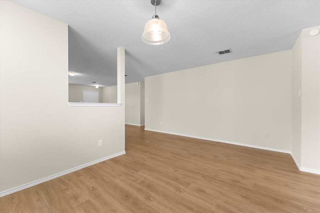 2633 Salt Maker Way Little Elm, TX 75068 - Photo 32 of 40 a view of an empty room with wooden floor