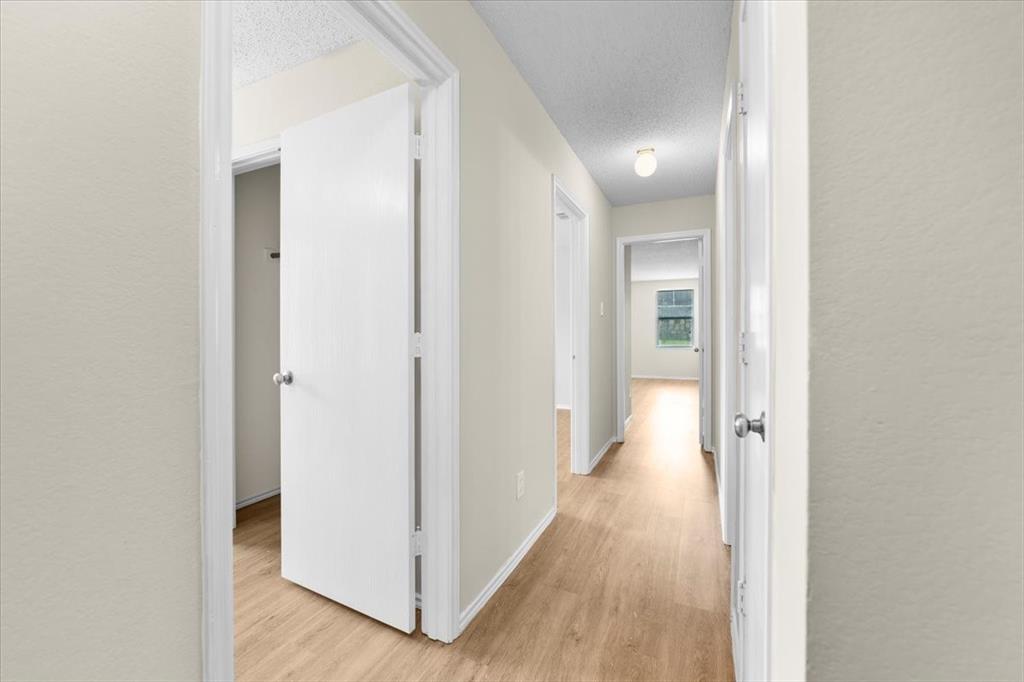 2633 Salt Maker Way Little Elm, TX 75068 - Photo 39 of 40 a view of a hallway with wooden floor