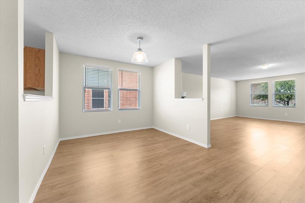 2633 Salt Maker Way Little Elm, TX 75068 - Photo 6 of 40 an empty room with wooden floor and windows