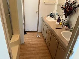 a bathroom with sink a mirror a vanity and toilet