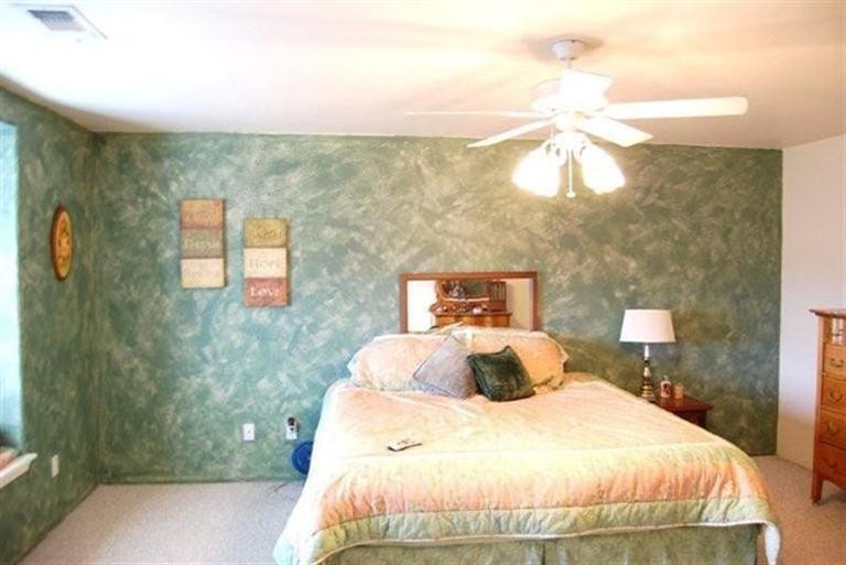 660 Shadow Way Central Point, OR 97502 - Photo 9 of 18 a bedroom with a bed and a chandelier