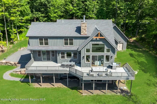 a aerial view of a house with a yard table and chairs