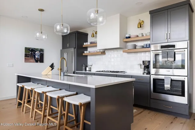 a living room with furniture a fireplace and a chandelier