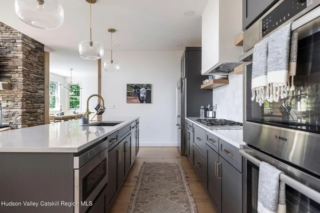 a hallway with a large mirror and a sink