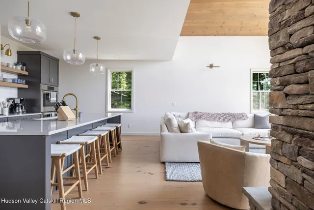 a dining room with furniture a chandelier and window