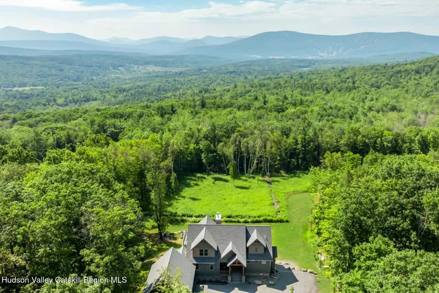 a aerial view of a house with a yard table and chairs