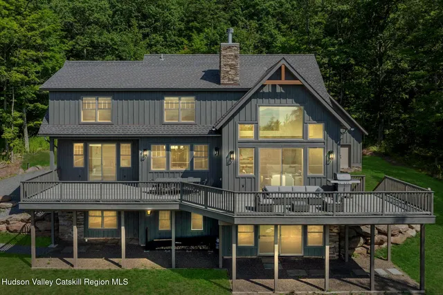 a living room with fireplace furniture and a flat screen tv