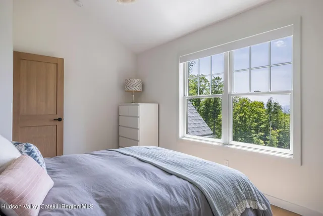 a view of a hallway with wooden floor and stairs