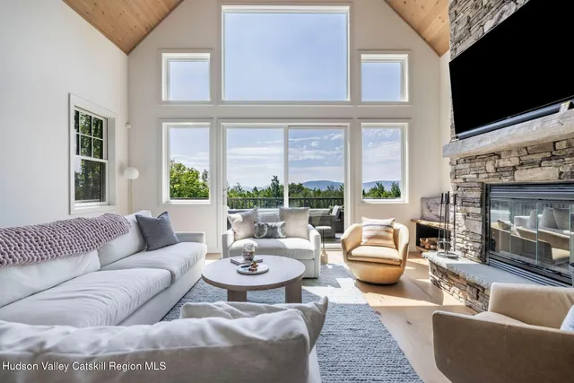 a living room with fireplace furniture and a flat screen tv