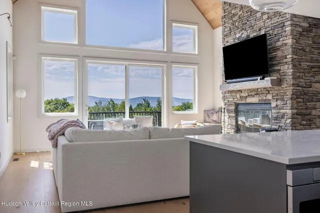 a living room with furniture a flat screen tv and a fireplace
