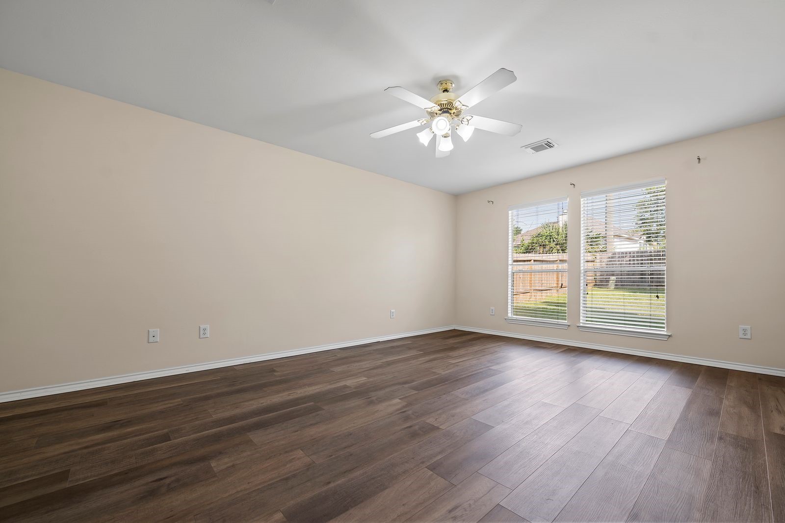 15311 Redbud Berry Way Cypress, TX 77433 - Photo 13 of 30 a view of an empty room with wooden floor and a window