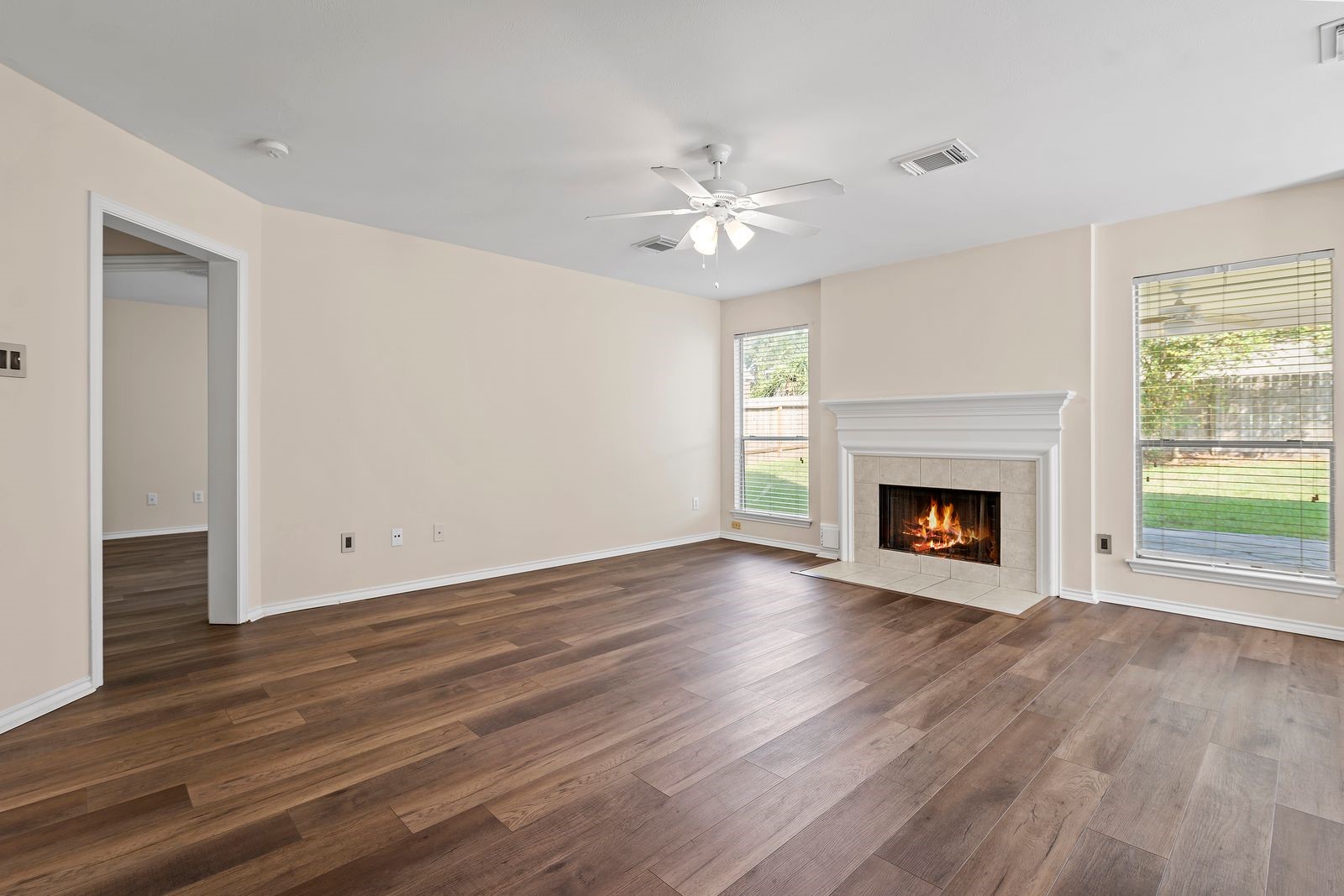 15311 Redbud Berry Way Cypress, TX 77433 - Photo 7 of 30 a view of an empty room with wooden floor fireplace and a window
