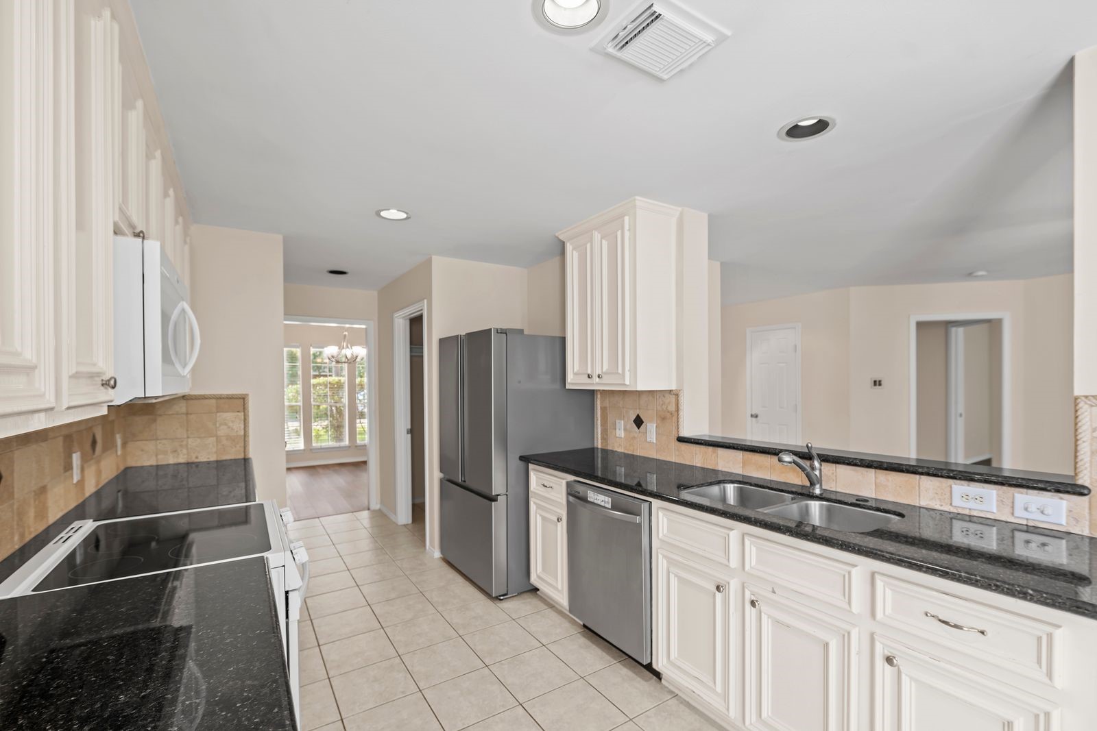 15311 Redbud Berry Way Cypress, TX 77433 - Photo 10 of 30 a kitchen with stainless steel appliances a refrigerator and a sink