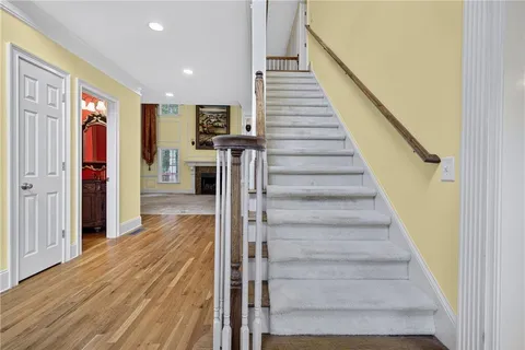 a view of entryway and hall with wooden floor