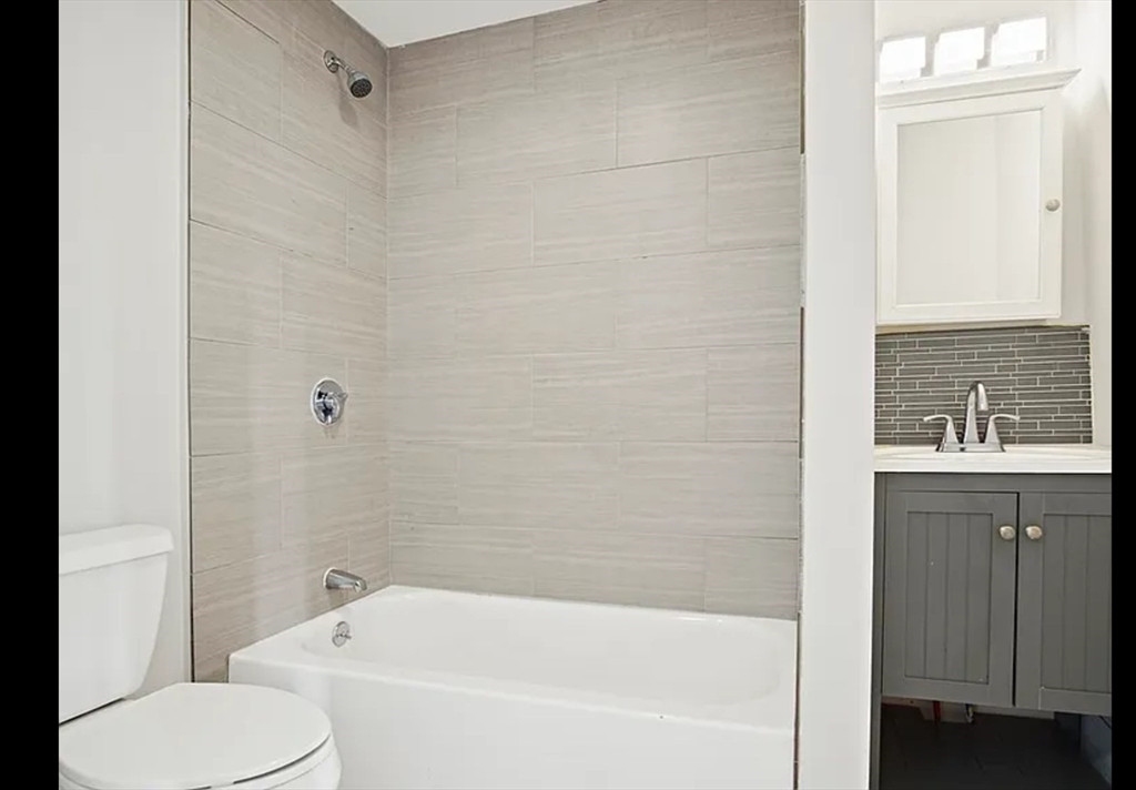 2 Redfield Street, Unit 2 Boston, MA 02122 - Photo 7 of 14 a white bath tub sitting next to a white toilet