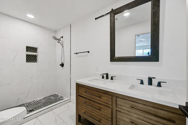 a bathroom with a double vanity sink mirror and
