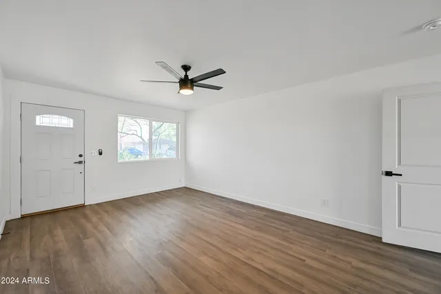 wooden floor in an empty room with a window
