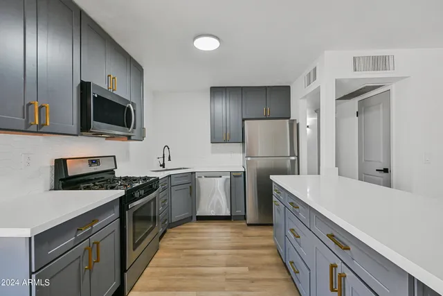 a kitchen with a sink stove and refrigerator