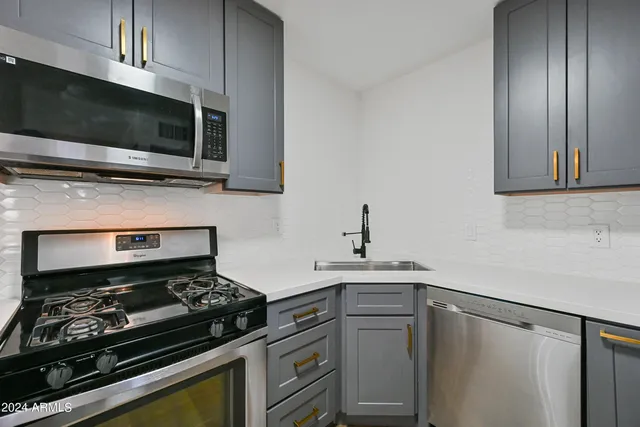 a kitchen with a stove and a microwave