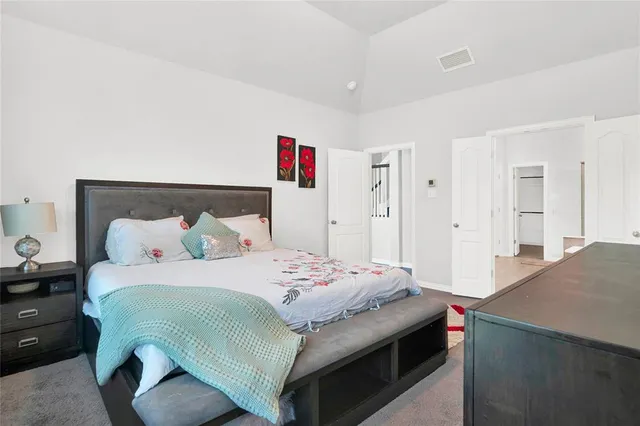 a bedroom with a bed and a large window