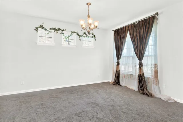 an empty room with windows and stairs