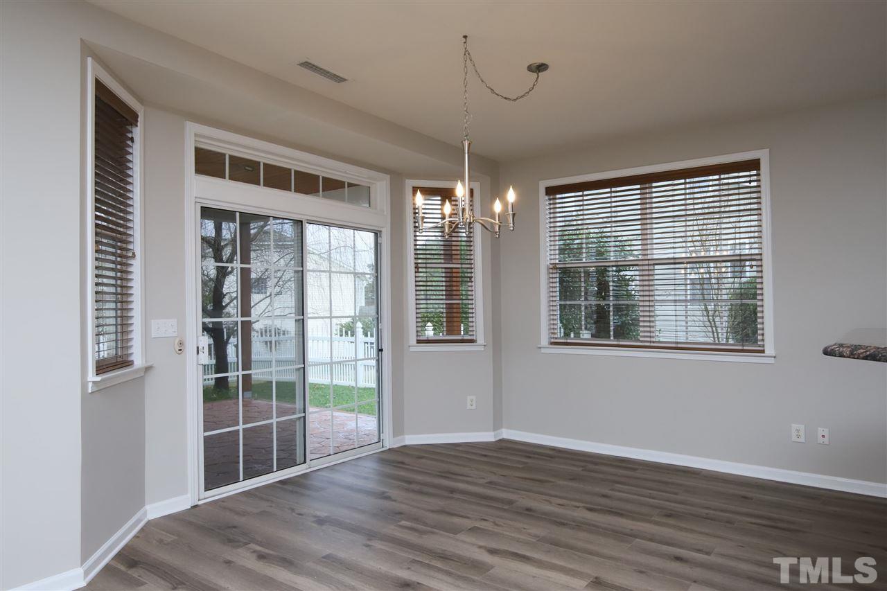 175 Solheim Lane Raleigh, NC 27603 - Photo 7 of 26 a view of an empty room with wooden floor and a window