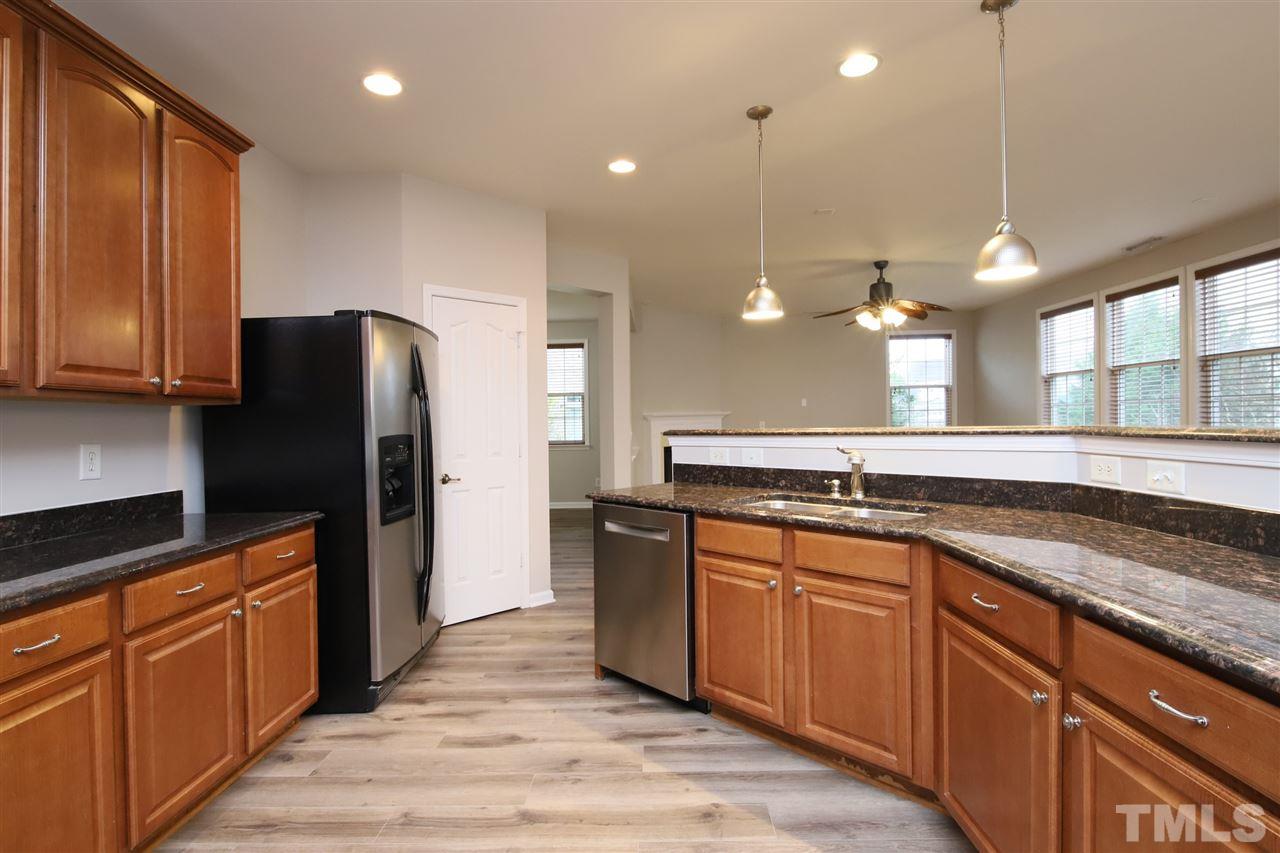 175 Solheim Lane Raleigh, NC 27603 - Photo 9 of 26 a large kitchen with stainless steel appliances wooden cabinets and a refrigerator