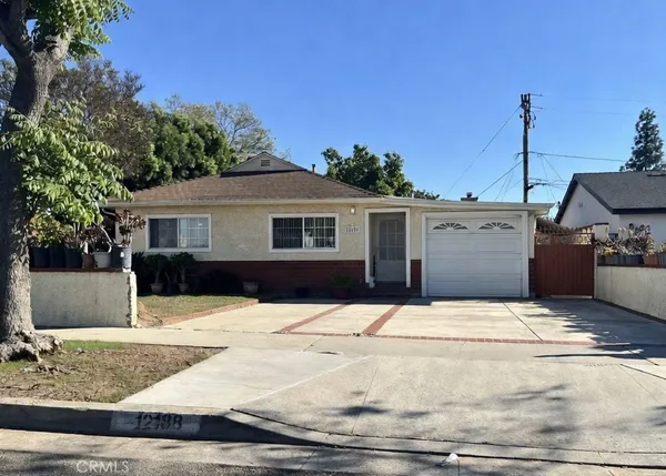 a front view of a house with trees
