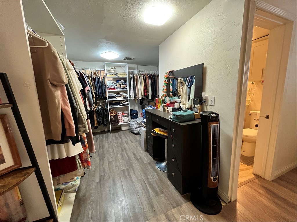 12188 Oracle Street Norwalk, CA 90650 - Photo 14 of 29 a view of a hallway with wooden floor and staircase