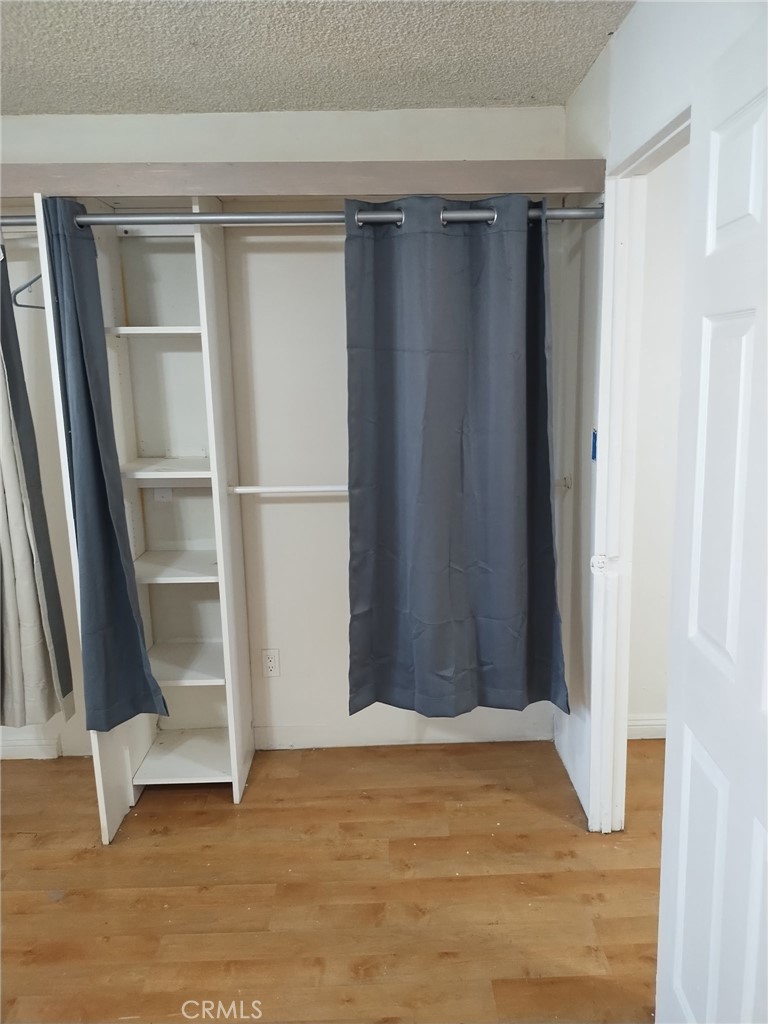 12188 Oracle Street Norwalk, CA 90650 - Photo 21 of 29 a view of an empty room with wooden floor and closet