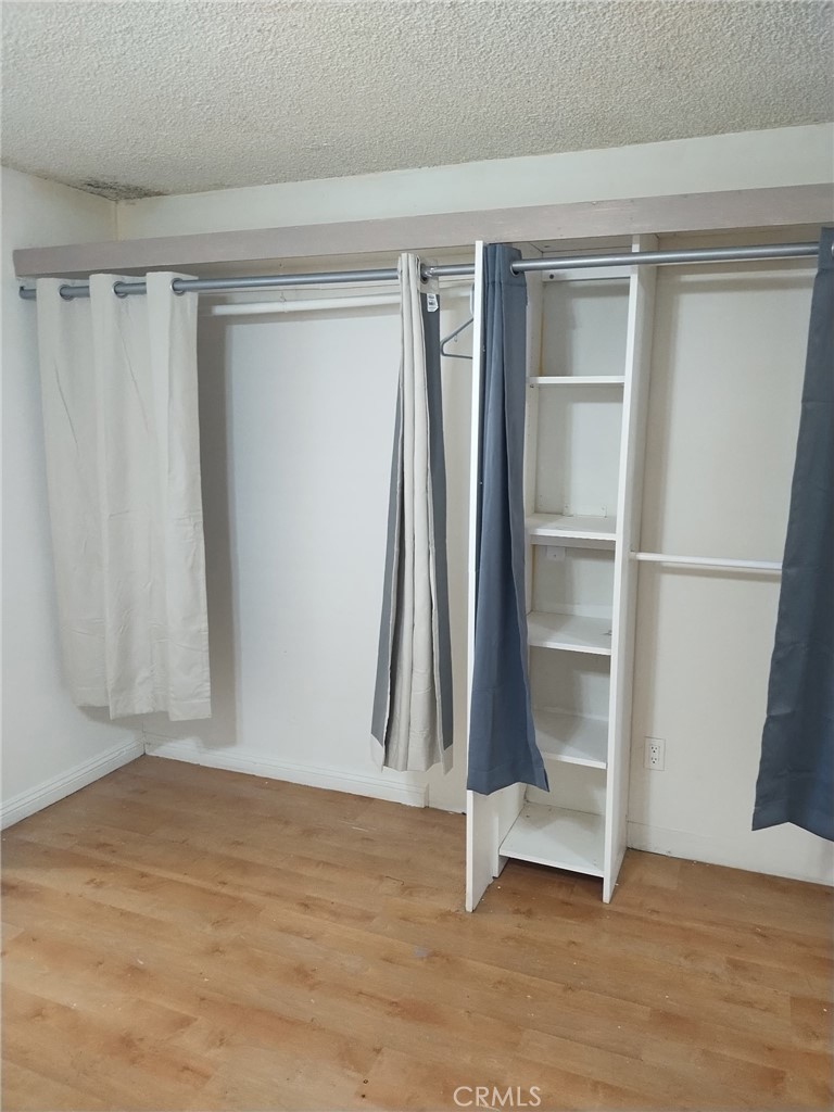 12188 Oracle Street Norwalk, CA 90650 - Photo 22 of 29 a view of an empty room with wooden floor and a window