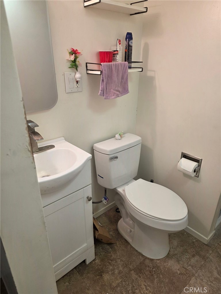 12188 Oracle Street Norwalk, CA 90650 - Photo 28 of 29 a white toilet sitting next to a bathroom sink