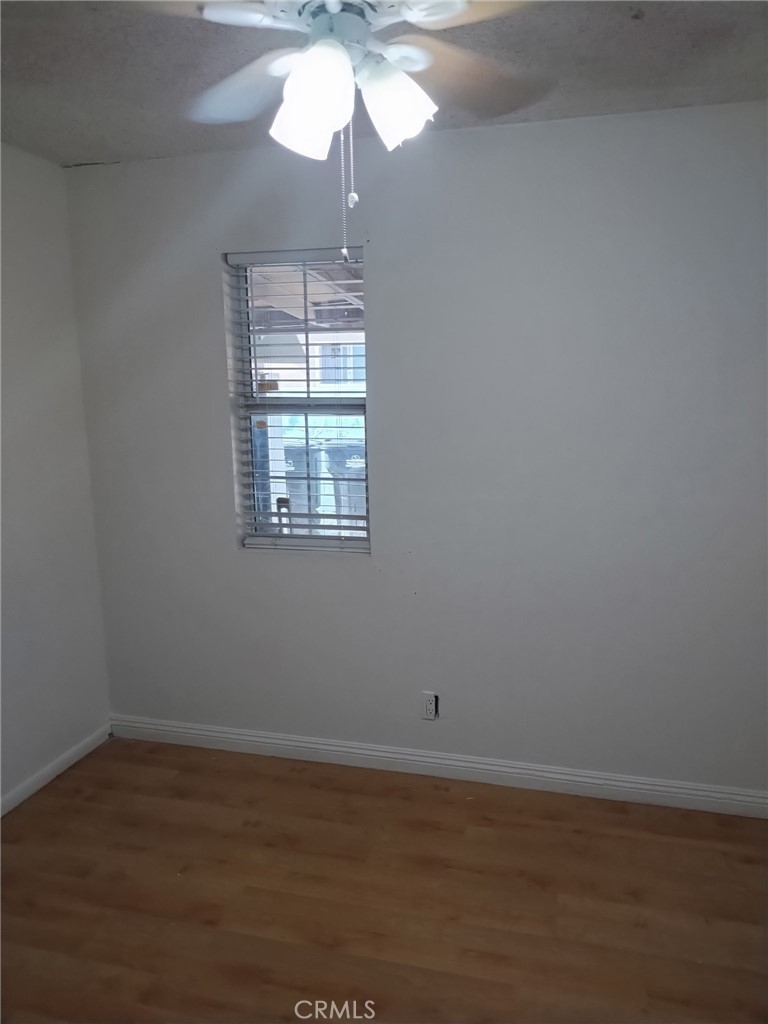 12188 Oracle Street Norwalk, CA 90650 - Photo 29 of 29 a view of an empty room with wooden floor and a window