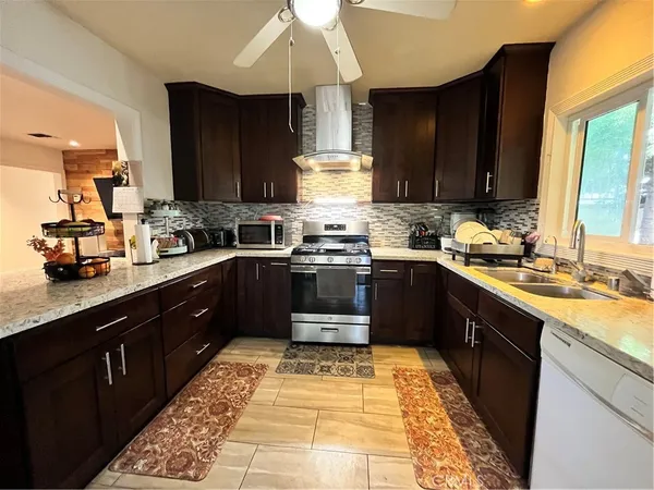 a kitchen with a sink stove top oven and cabinets