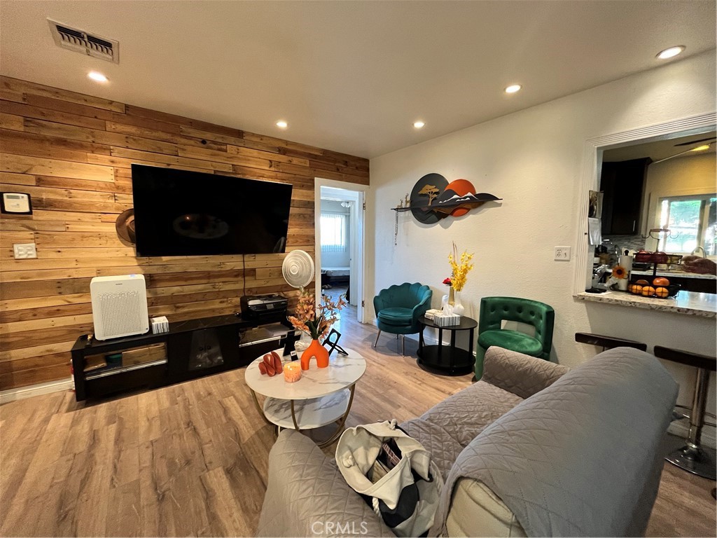 12188 Oracle Street Norwalk, CA 90650 - Photo 6 of 29 a living room with furniture and a flat screen tv