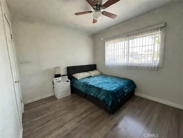 a bedroom with a bed and window