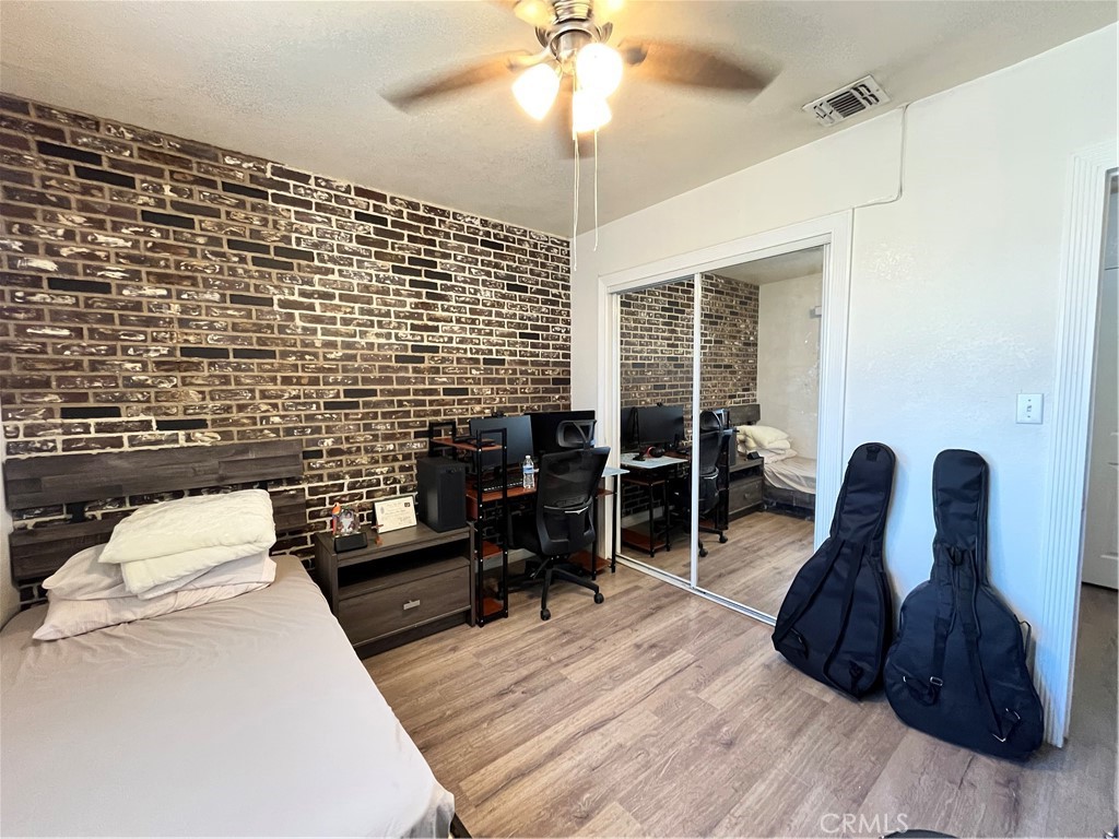 12188 Oracle Street Norwalk, CA 90650 - Photo 10 of 29 a work room with furniture and wooden floor