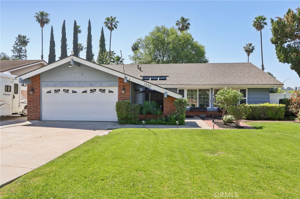 1250 Blazewood Street Riverside, CA 92507 - Photo 1 of 29 a front view of a house with a yard and garage