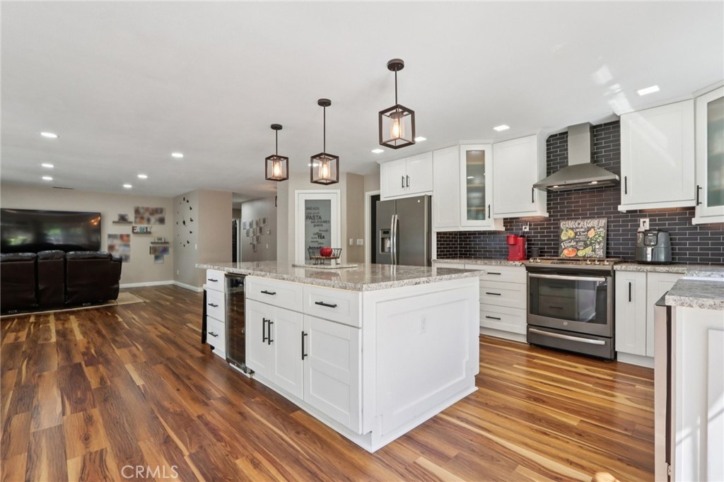 1250 Blazewood Street Riverside, CA 92507 - Photo 11 of 29 a kitchen with stainless steel appliances kitchen island granite countertop a stove and a sink
