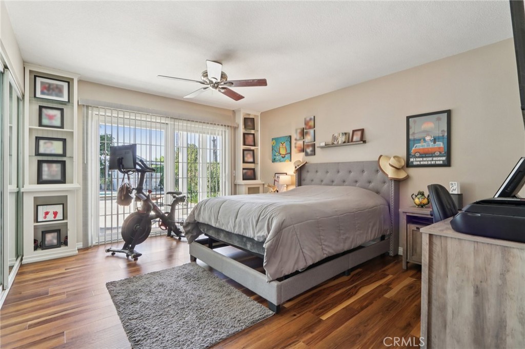 1250 Blazewood Street Riverside, CA 92507 - Photo 12 of 29 a bedroom with a bed a large window and wooden floor