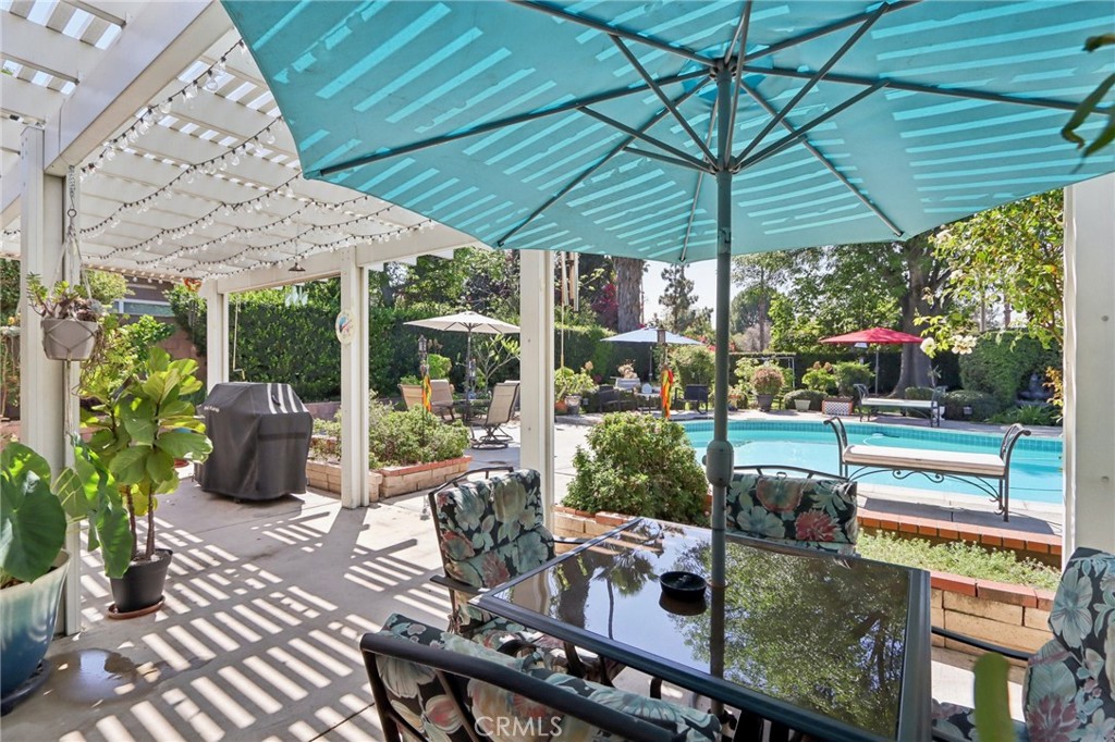 1250 Blazewood Street Riverside, CA 92507 - Photo 21 of 29 a view of a patio with table and chairs under an umbrella