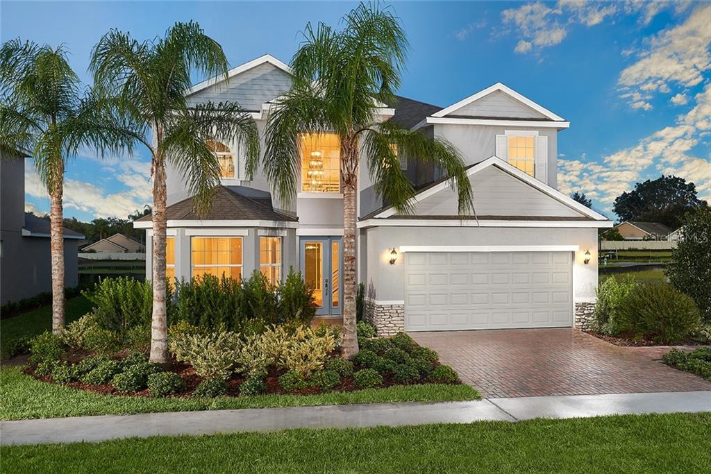 a front view of house with yard and green space