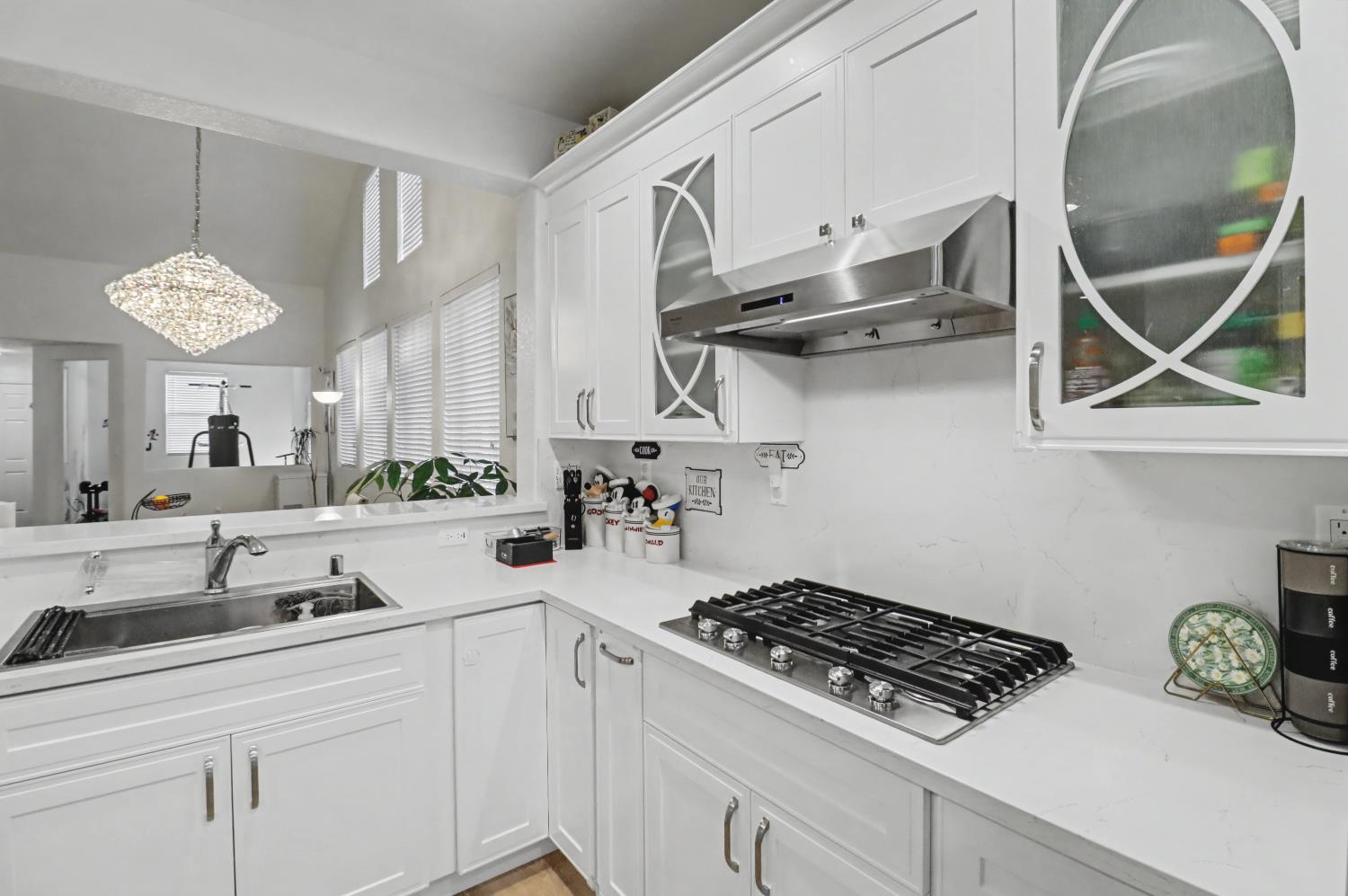 10056 Wexted Way Elk Grove, CA 95757 - Photo 19 of 39 a kitchen with stainless steel appliances a sink a stove and cabinets