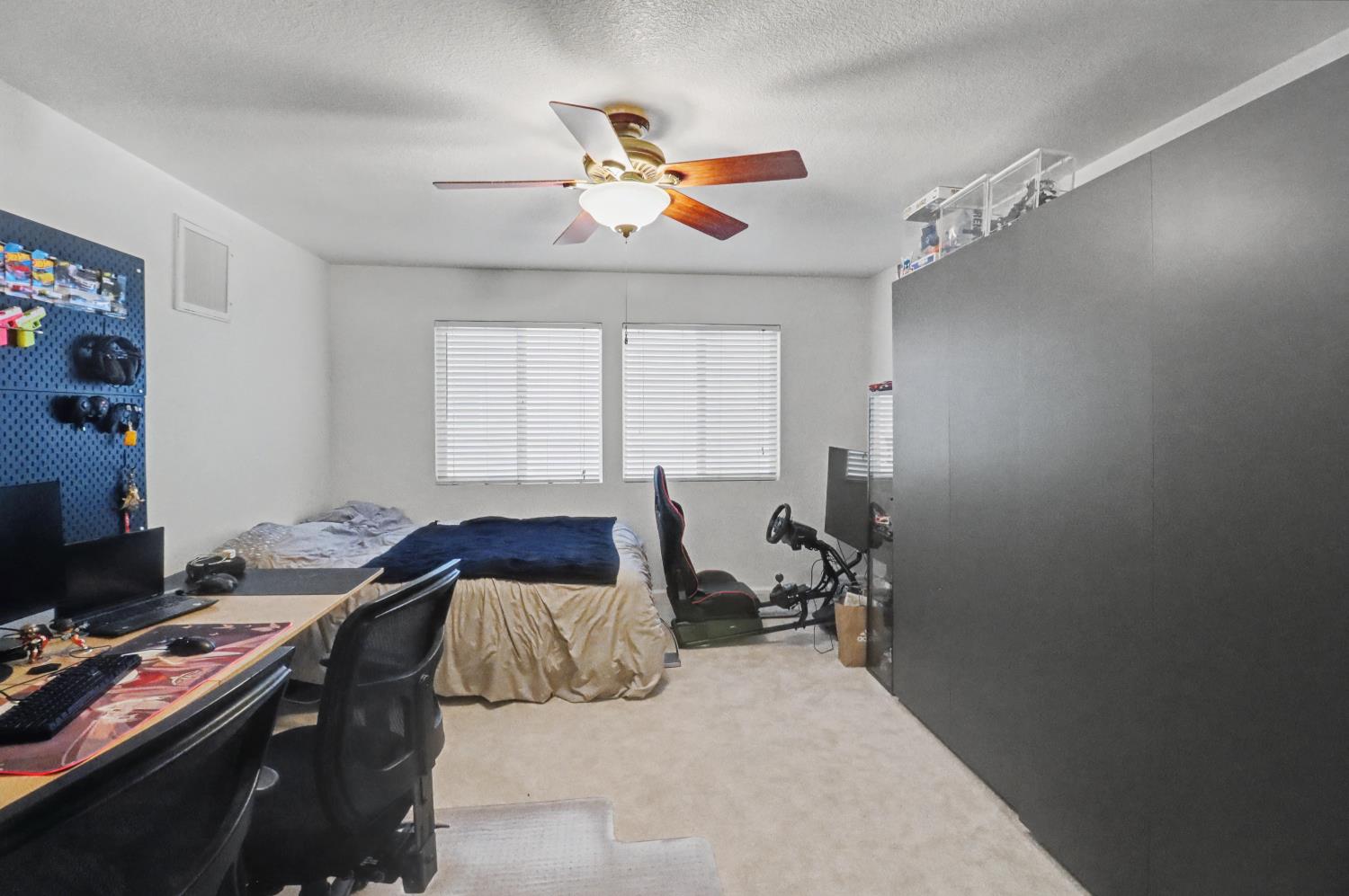 10056 Wexted Way Elk Grove, CA 95757 - Photo 26 of 39 a bedroom that has a bed and a chandelier