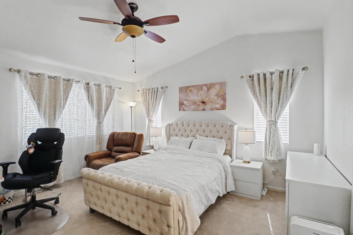 10056 Wexted Way Elk Grove, CA 95757 - Photo 32 of 39 a bedroom with a bed and a chandelier